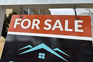 A sale sign stands outside a condominium on the market Wednesday, Feb. 21, 2024, in Denver. . (AP Photo/David Zalubowski)